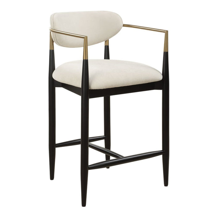 Moxie Counter Stool - matte black wood frame with brushed brass arms and off white velvet upholstery