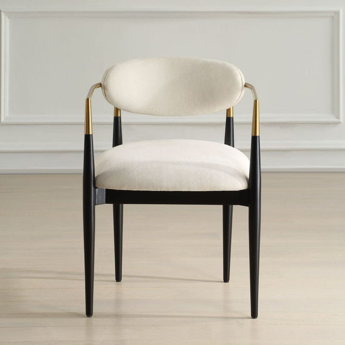 Moxie Dining Arm Chair - matte black wood frame with brushed brass arms and off white velvet upholstery