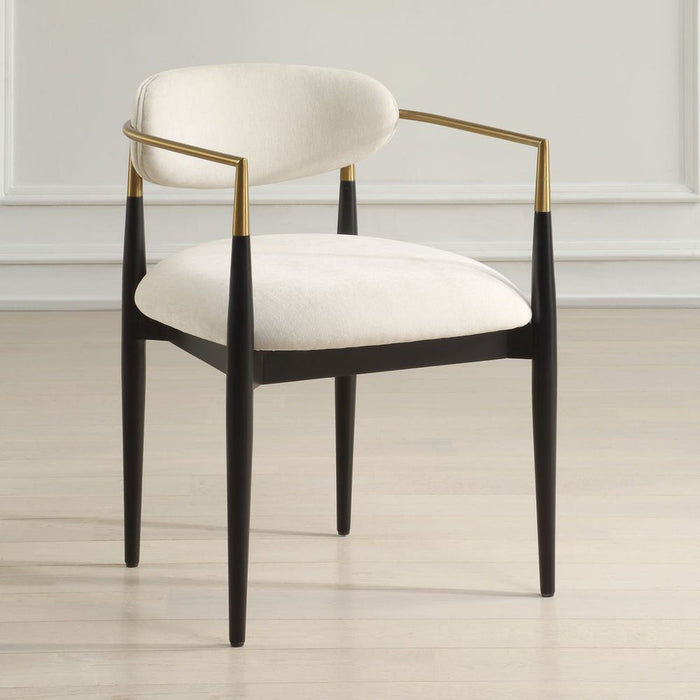 Moxie Dining Arm Chair - matte black wood frame with brushed brass arms and off white velvet upholstery